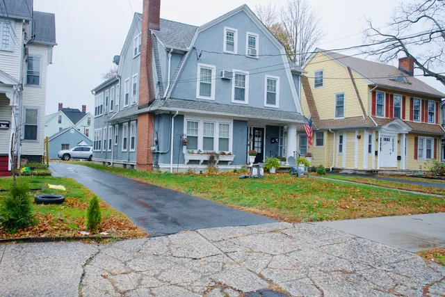 a front view of a residential apartment building with a yard