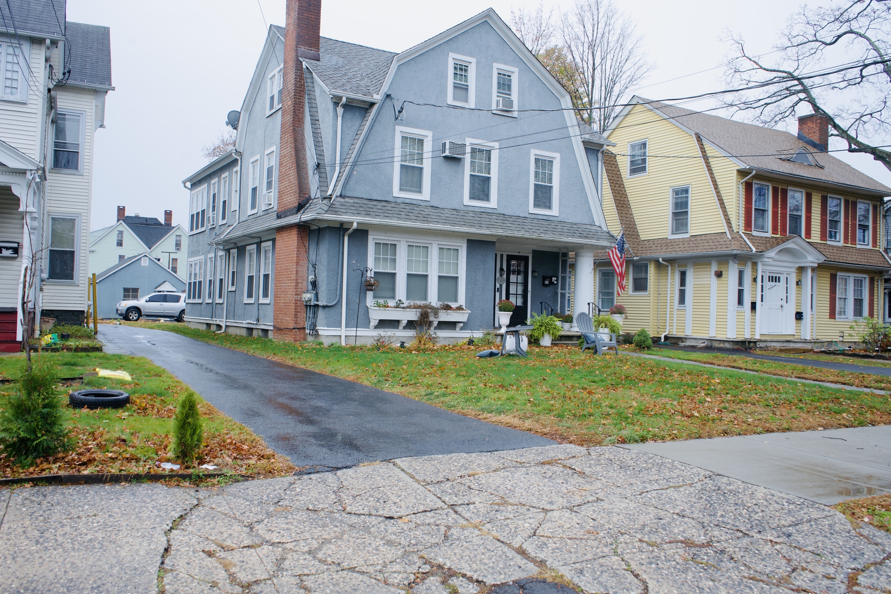 533 Clinton Avenue Bridgeport, CT 06605 - Photo 3 of 18 a front view of a residential apartment building with a yard