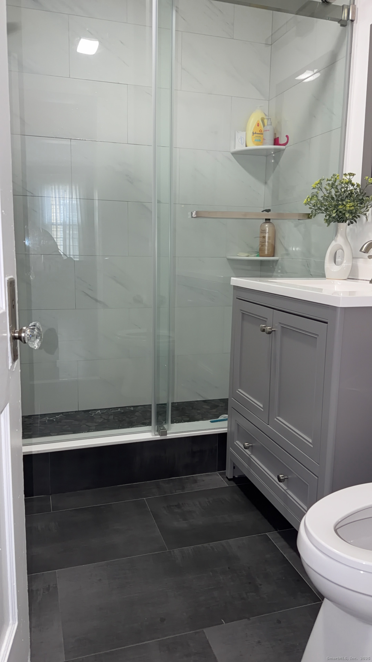 533 Clinton Avenue Bridgeport, CT 06605 - Photo 7 of 18 a bathroom with a sink a toilet a mirror and vanity