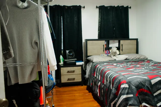 a bed sitting in a bedroom next to a window