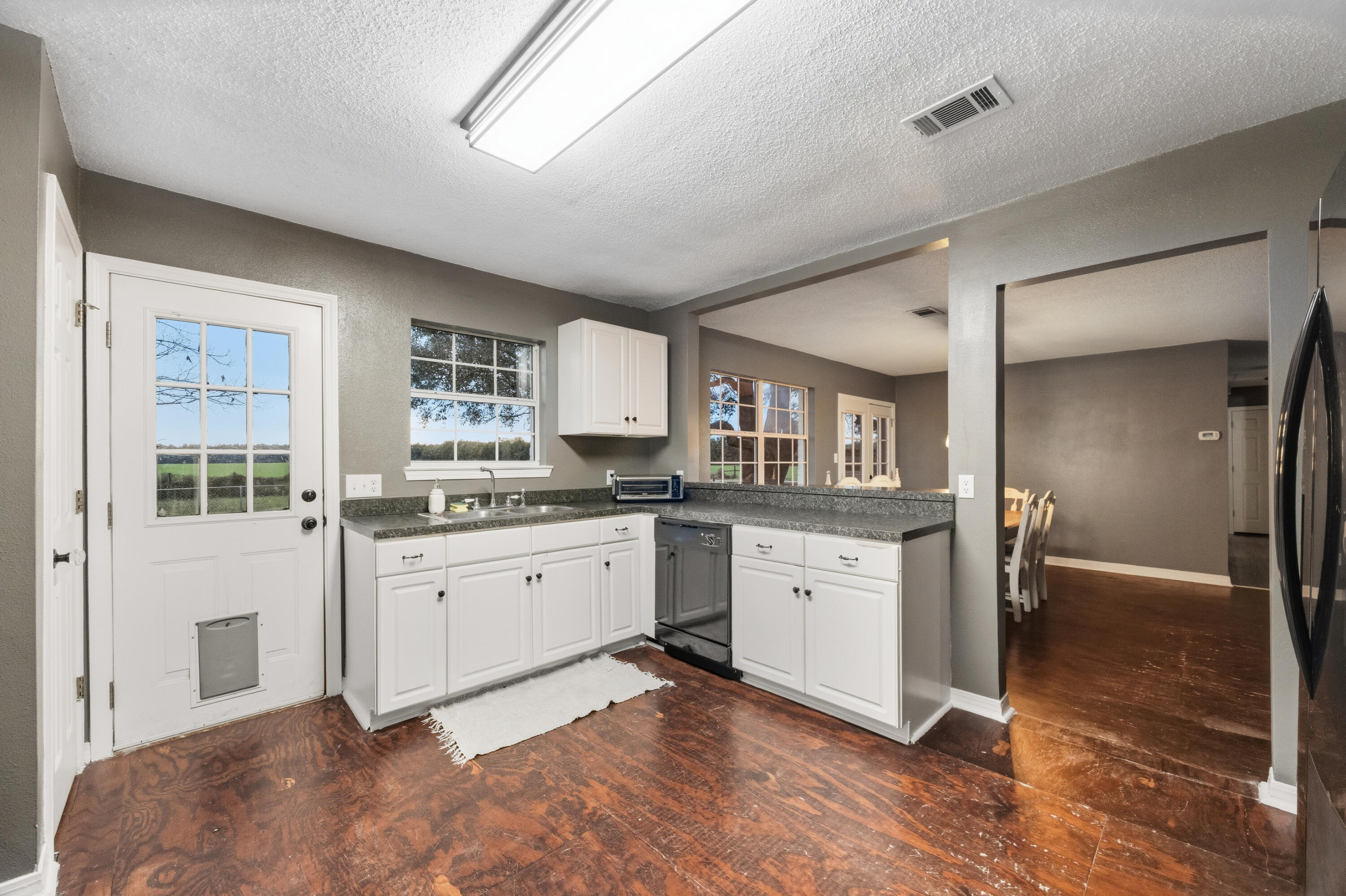 4398 Cooper Lane Holt, FL 32564 - Photo 15 of 53 a kitchen with granite countertop cabinets a sink and appliances