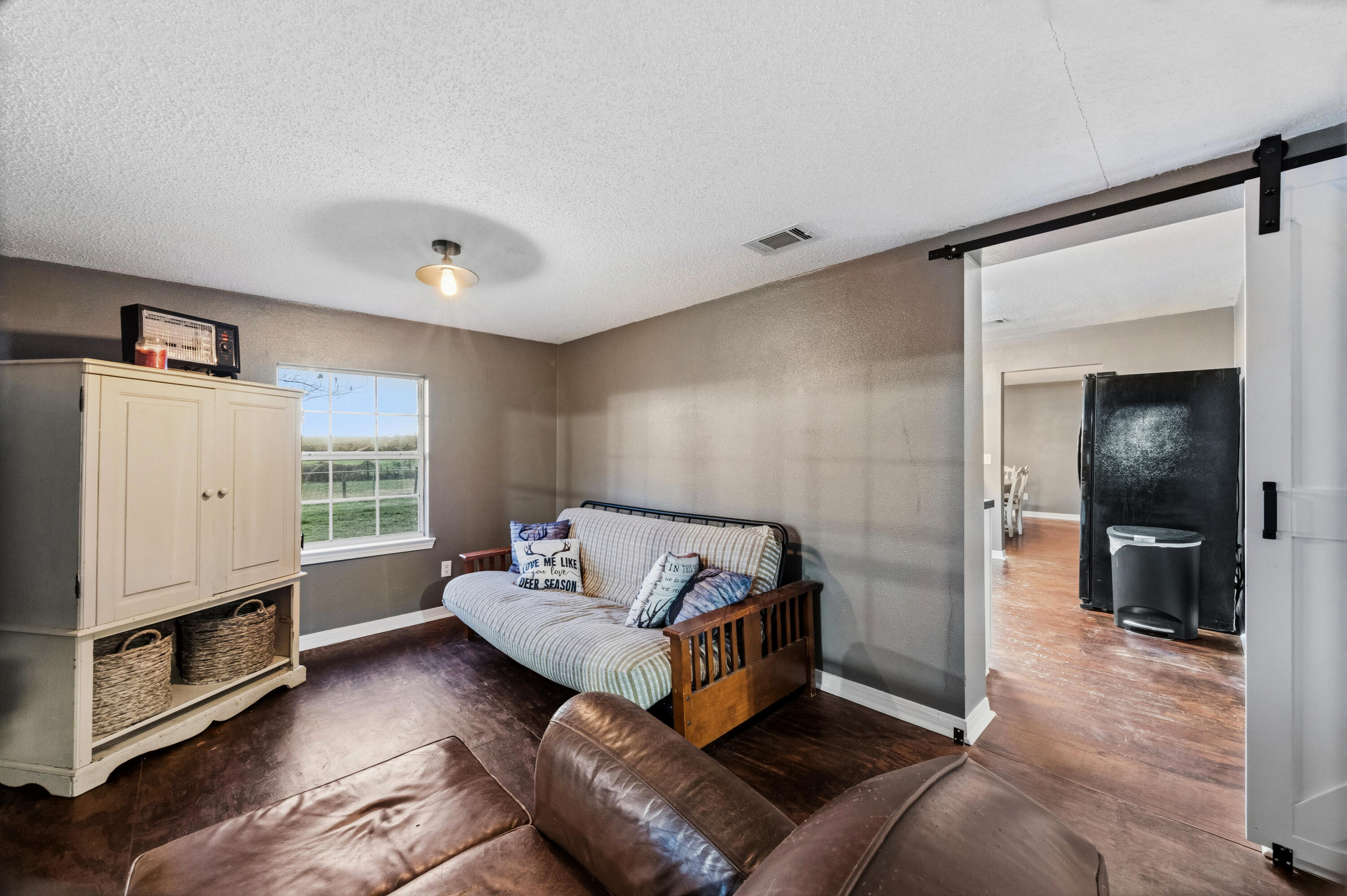 4398 Cooper Lane Holt, FL 32564 - Photo 22 of 53 a living room with furniture and a window