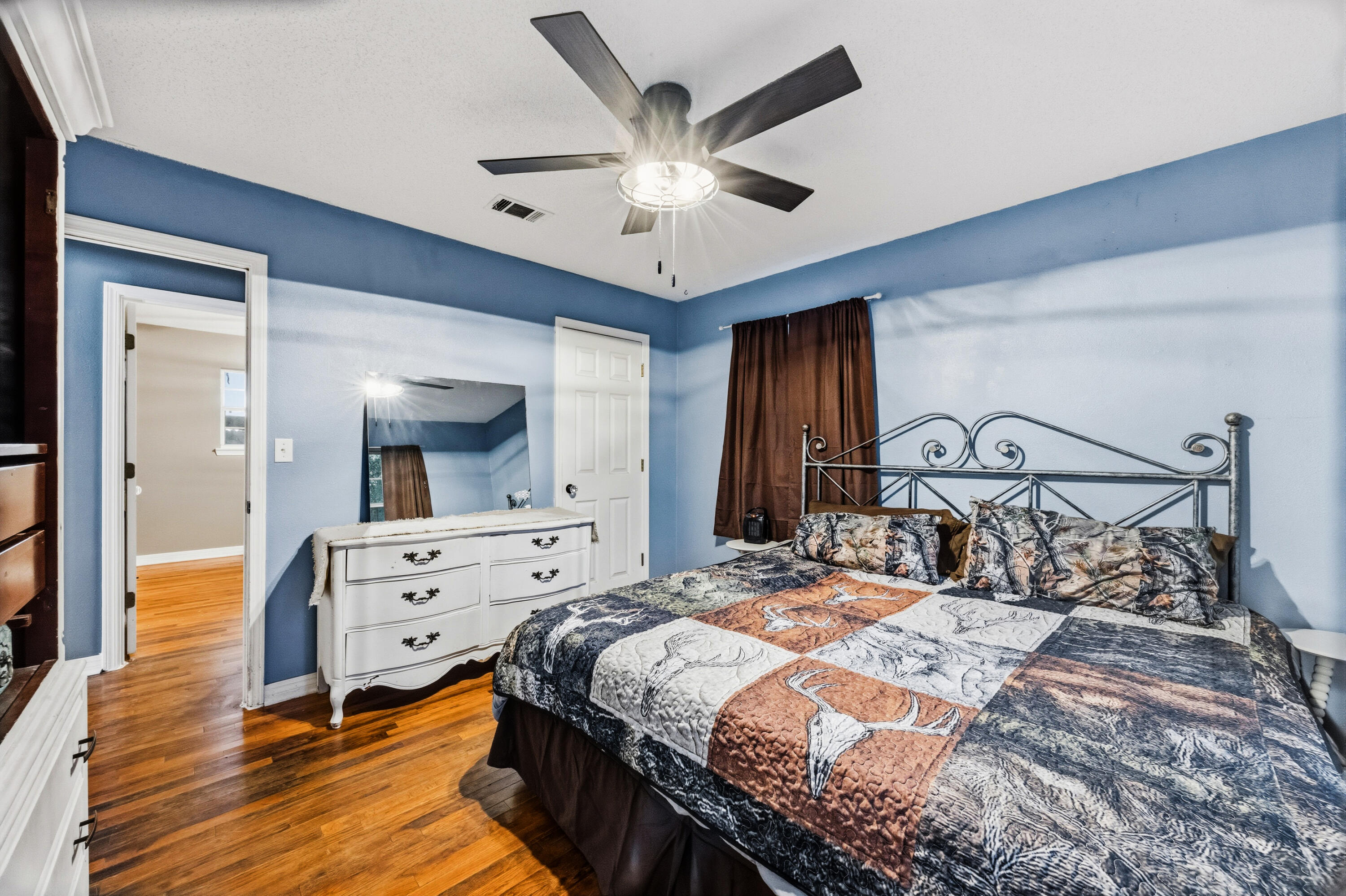4398 Cooper Lane Holt, FL 32564 - Photo 25 of 53 a bedroom with a bed and a chandelier