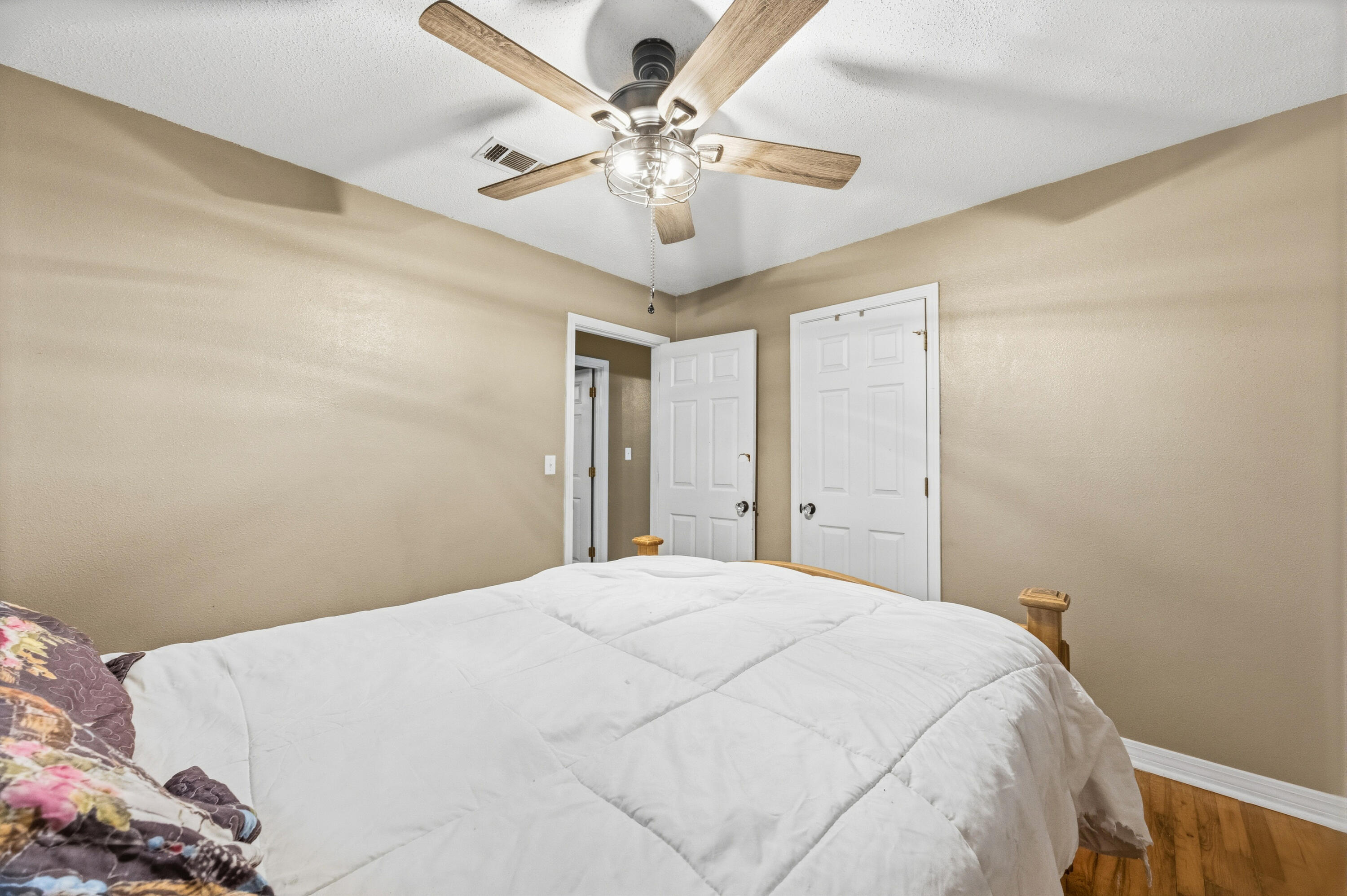 4398 Cooper Lane Holt, FL 32564 - Photo 29 of 53 a bedroom with a large bed and a chandelier