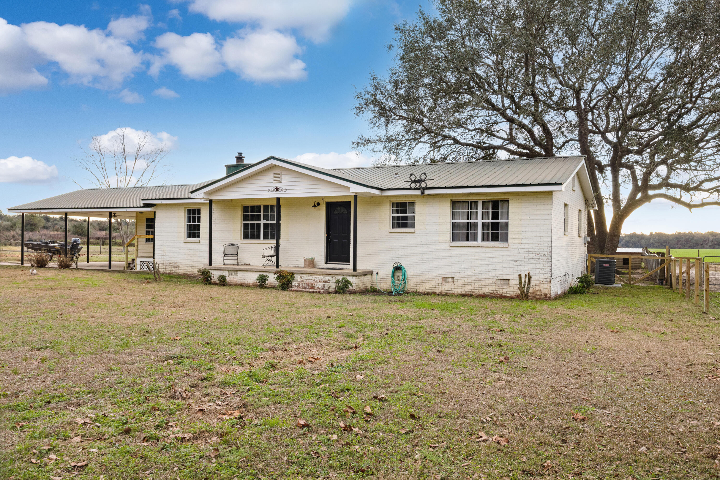 4398 Cooper Lane Holt, FL 32564 - Photo 3 of 53 a front view of a house with a garden