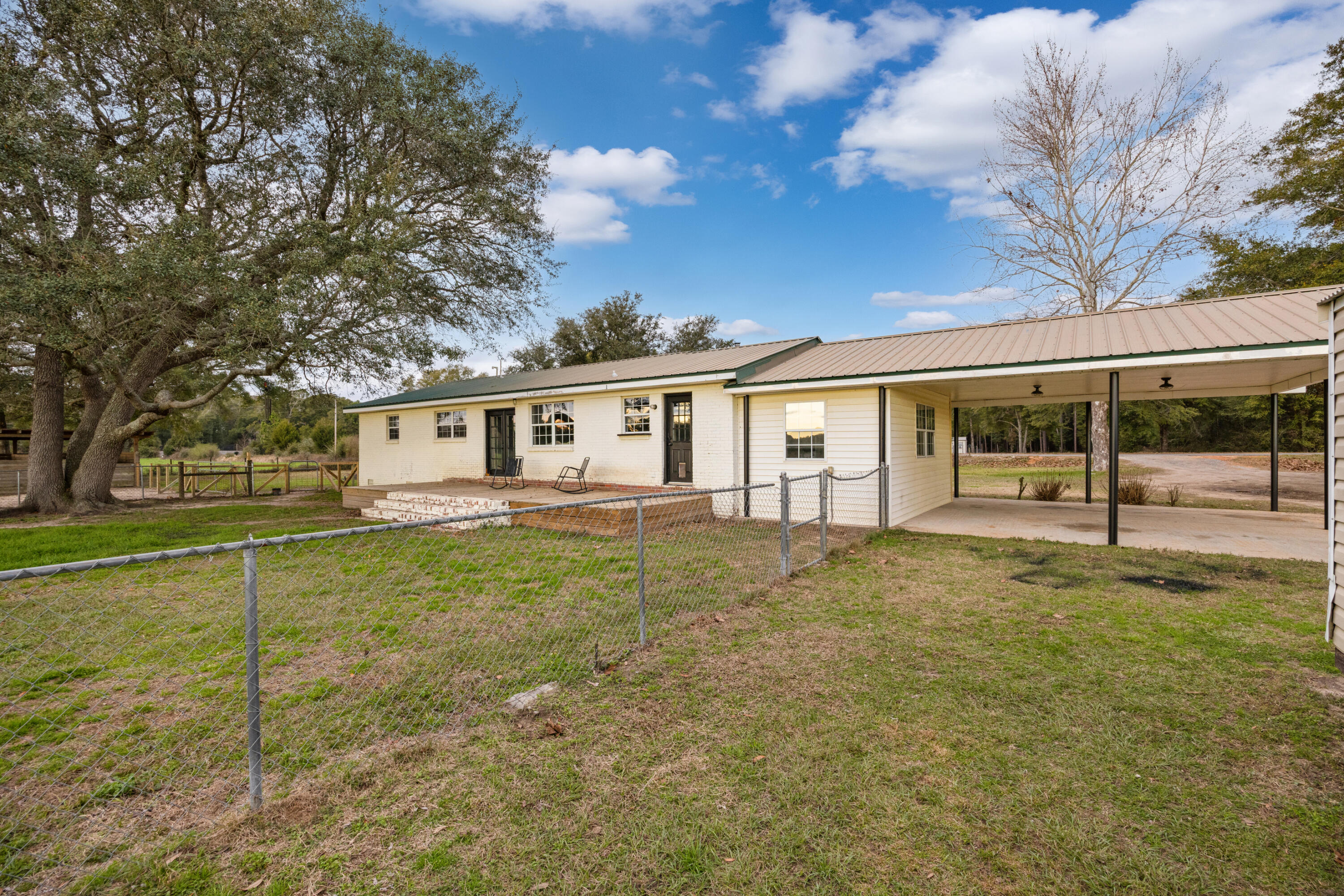 4398 Cooper Lane Holt, FL 32564 - Photo 36 of 53 a house with trees in the background