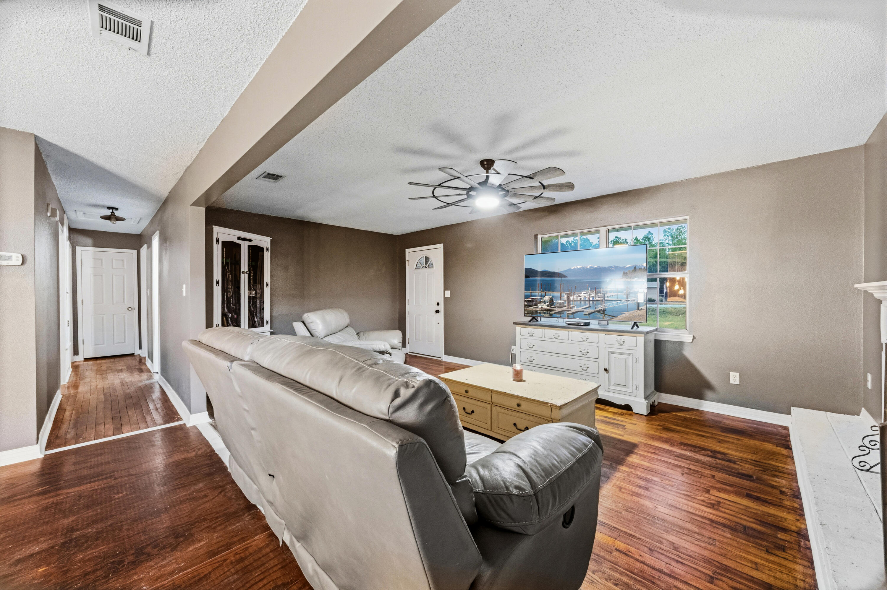 4398 Cooper Lane Holt, FL 32564 - Photo 7 of 53 a living room with furniture and a chandelier