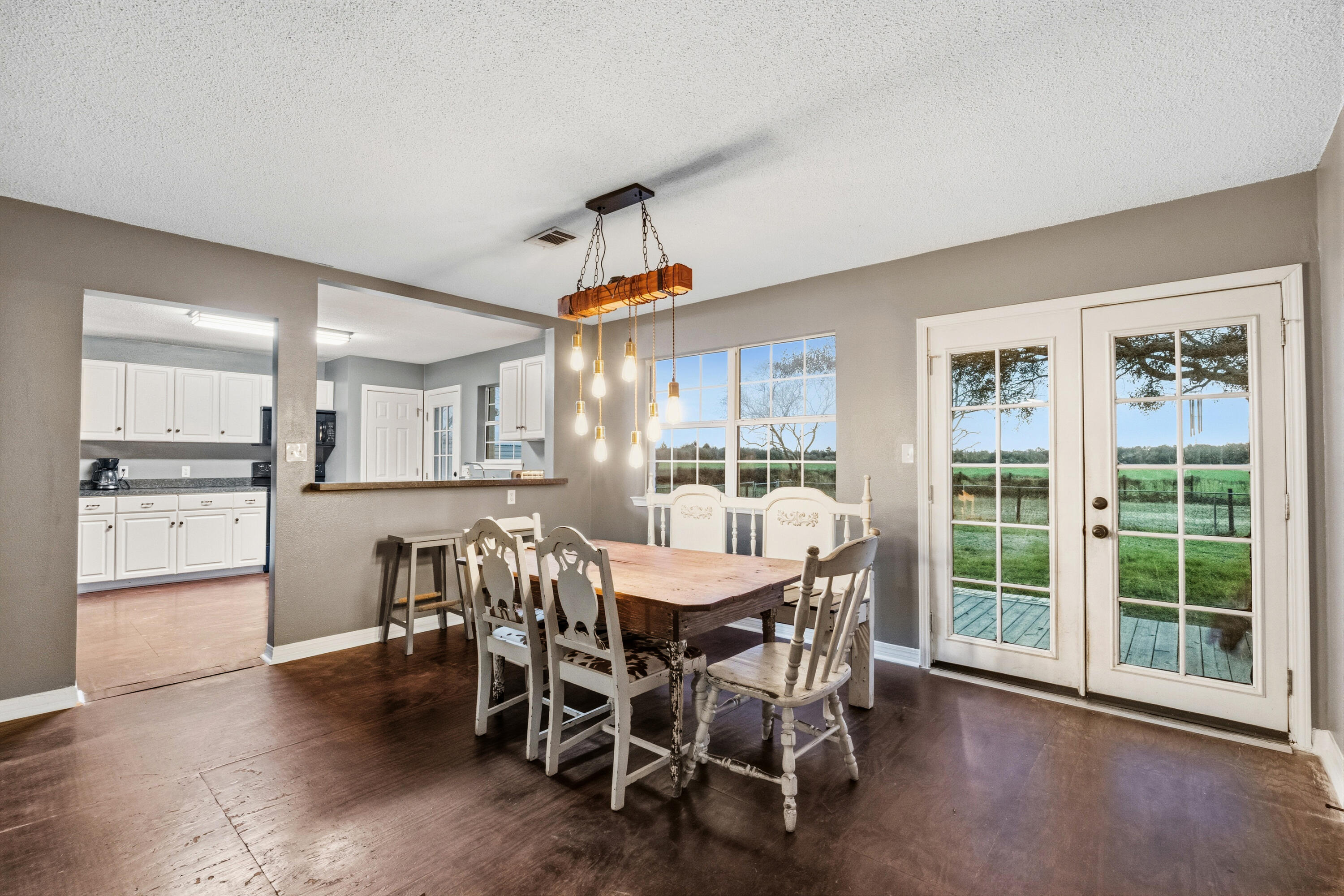 4398 Cooper Lane Holt, FL 32564 - Photo 10 of 53 a view of a dining room with furniture window and wooden floor