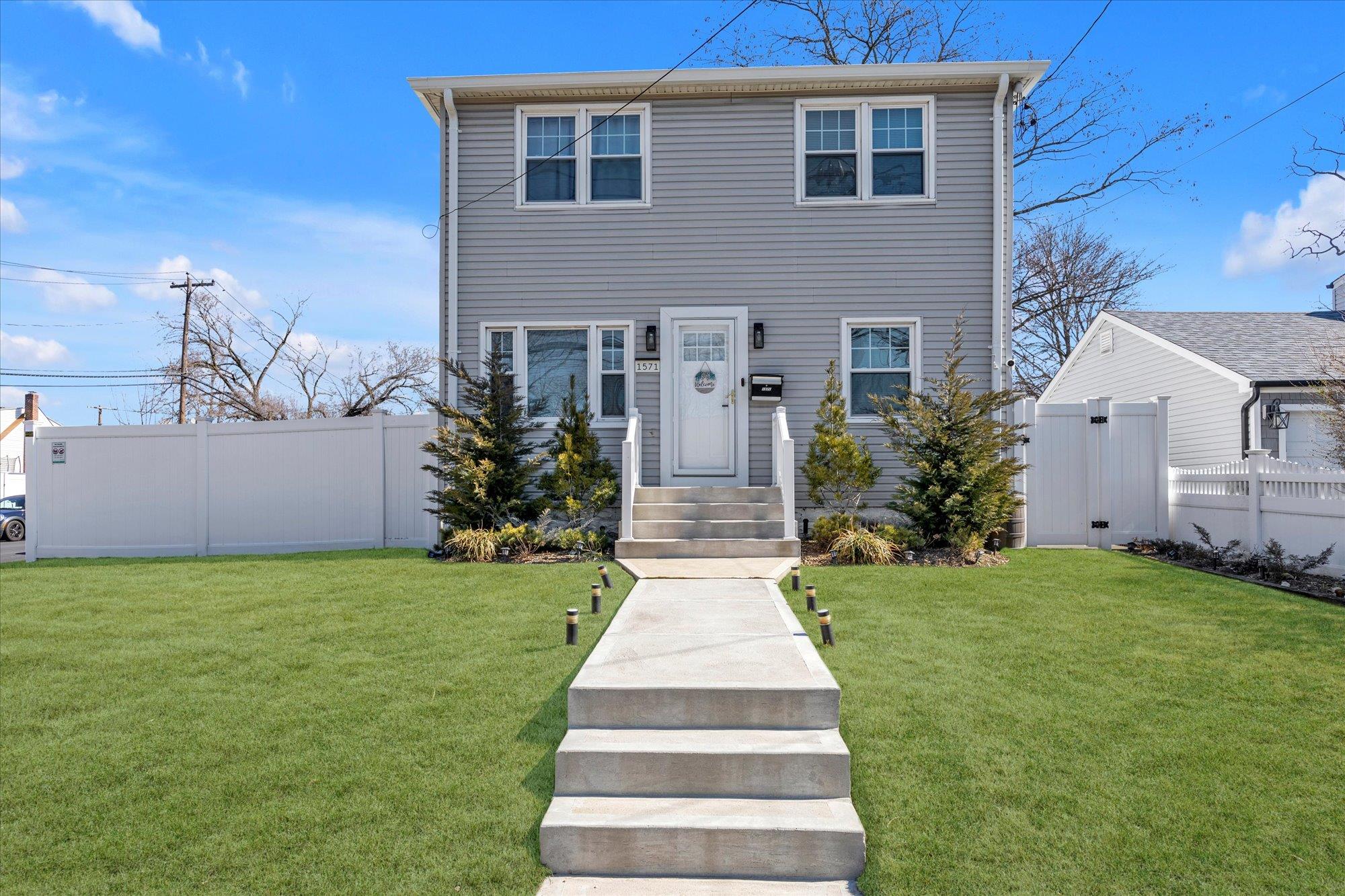 1571 Meadowbrook Road North Merrick, NY 11566 - Photo 1 of 1 a front view of a house with garden