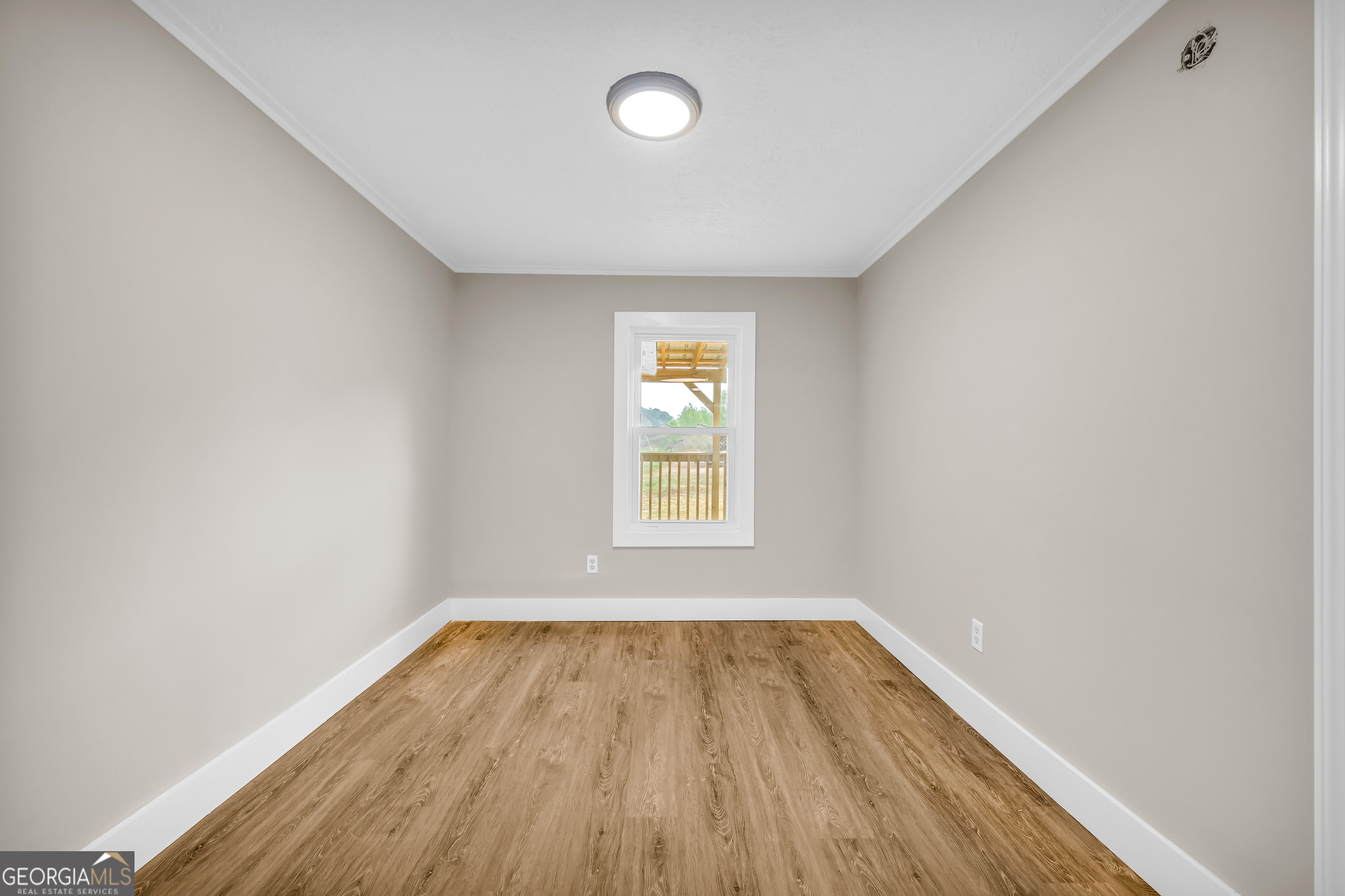 5620 Mize Road Toccoa, GA 30577 - Photo 25 of 37 an empty room with wooden floor and windows