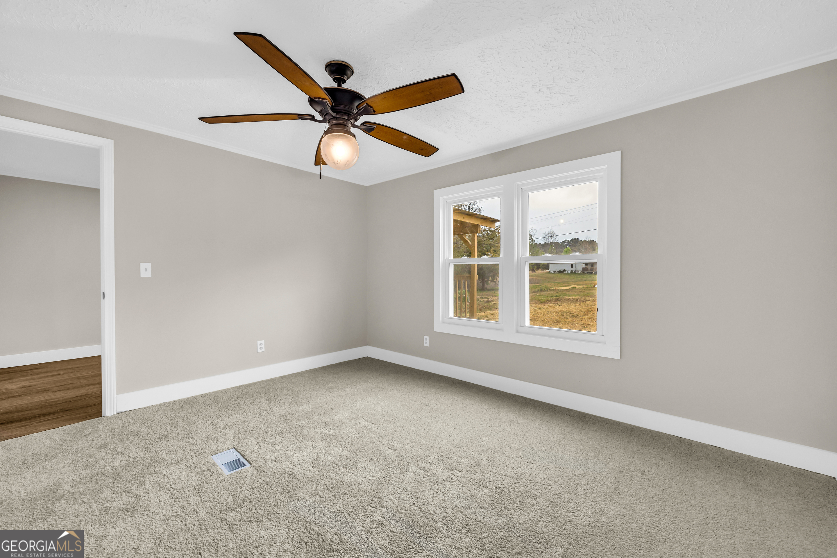 5620 Mize Road Toccoa, GA 30577 - Photo 29 of 37 an empty room with windows and fan
