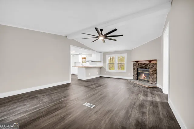a view of a livingroom with a hardwood floor and a ceiling fan
