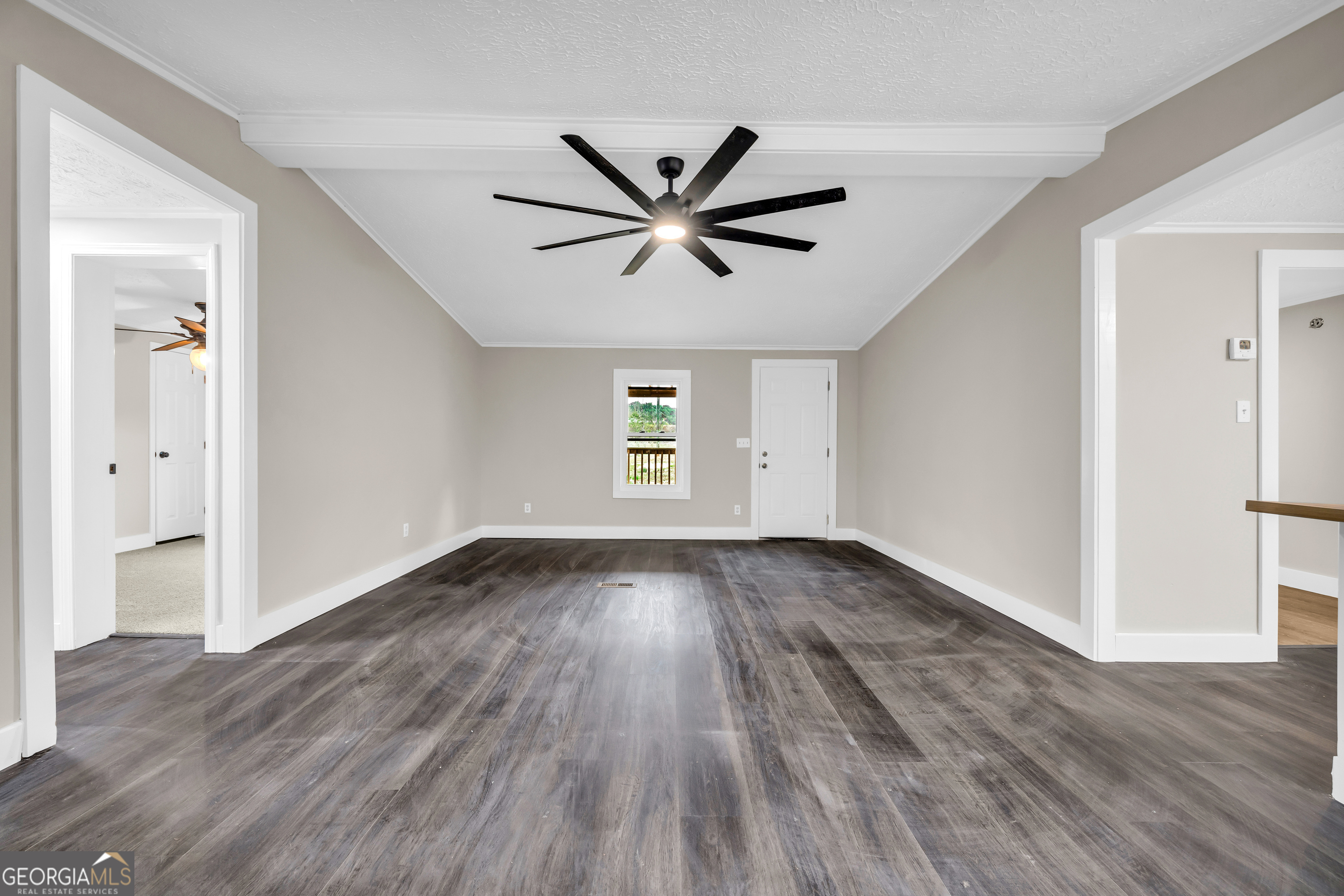 5620 Mize Road Toccoa, GA 30577 - Photo 9 of 37 a view of a livingroom with a hardwood floor and a ceiling fan