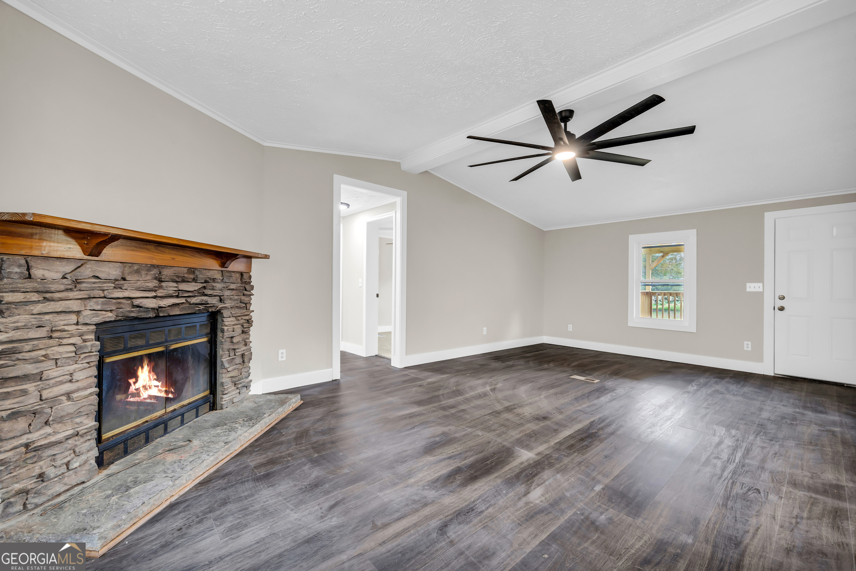 5620 Mize Road Toccoa, GA 30577 - Photo 10 of 37 a view of an empty room with wooden floor fireplace and a window