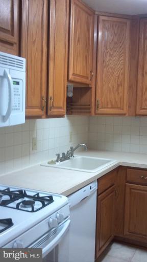 10547 Twin Rivers Road, Unit C1 Columbia, MD 21044 - Photo 1 of 6 a kitchen with sink cabinets and stove