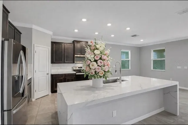 a kitchen with stainless steel appliances a sink and a refrigerator