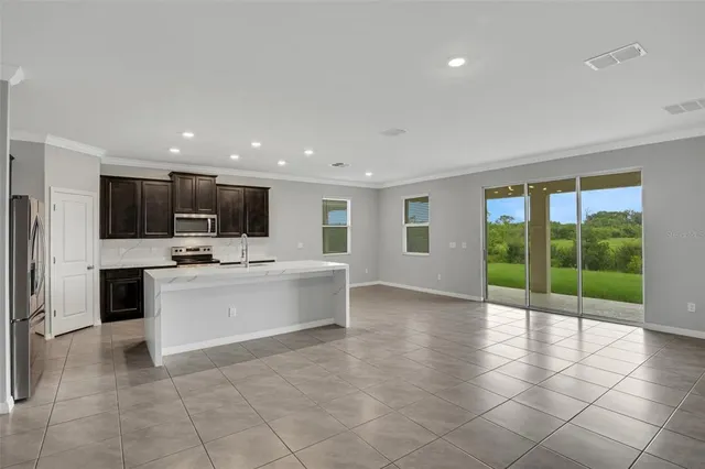 a view of kitchen with granite countertop lots of counter top space