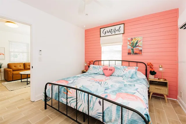 a bedroom with a bed and a window