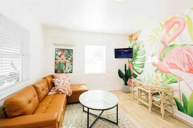 a living room with furniture and a potted plant