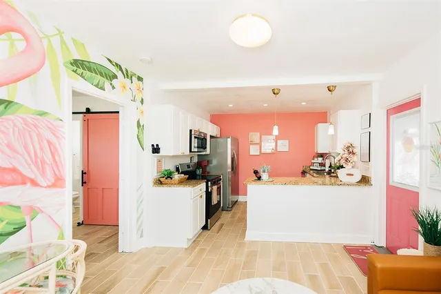 a view of a living room and kitchen