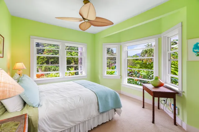 a bedroom with a bed and a large window