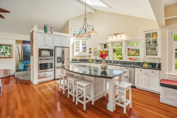 a kitchen with stainless steel appliances granite countertop a stove and a refrigerator