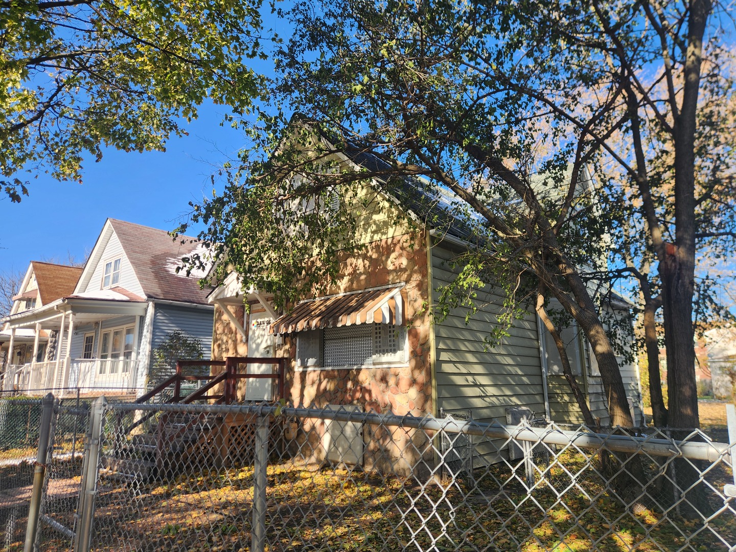 310 West 108th Place Chicago, IL 60628 - Photo 2 of 12 a front view of a house with a tree