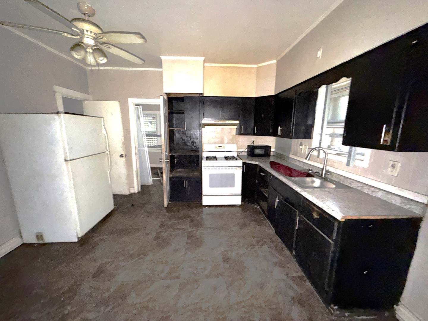 310 West 108th Place Chicago, IL 60628 - Photo 7 of 12 a kitchen with kitchen island a sink appliances and cabinets