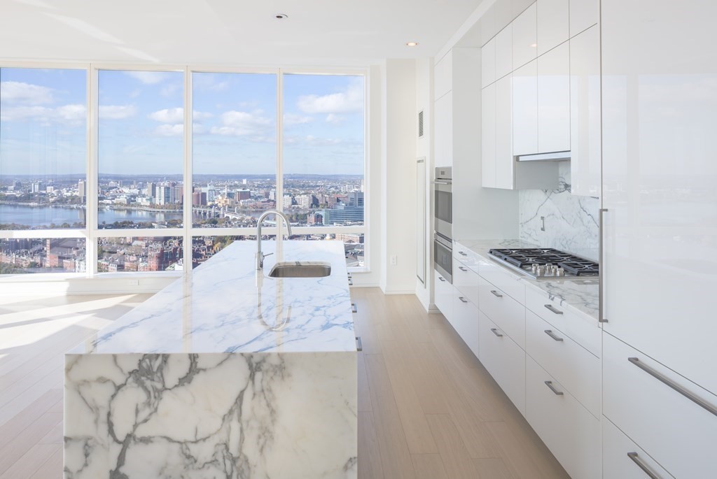 1 Franklin Street, Unit 3903 Boston, MA 02110 - Photo 3 of 26 a large white kitchen with a large window