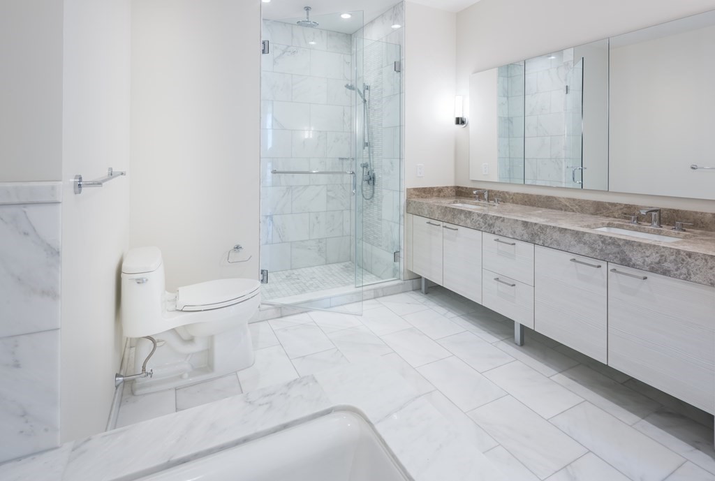 1 Franklin Street, Unit 3903 Boston, MA 02110 - Photo 6 of 26 a bathroom with a granite countertop sink mirror and toilet