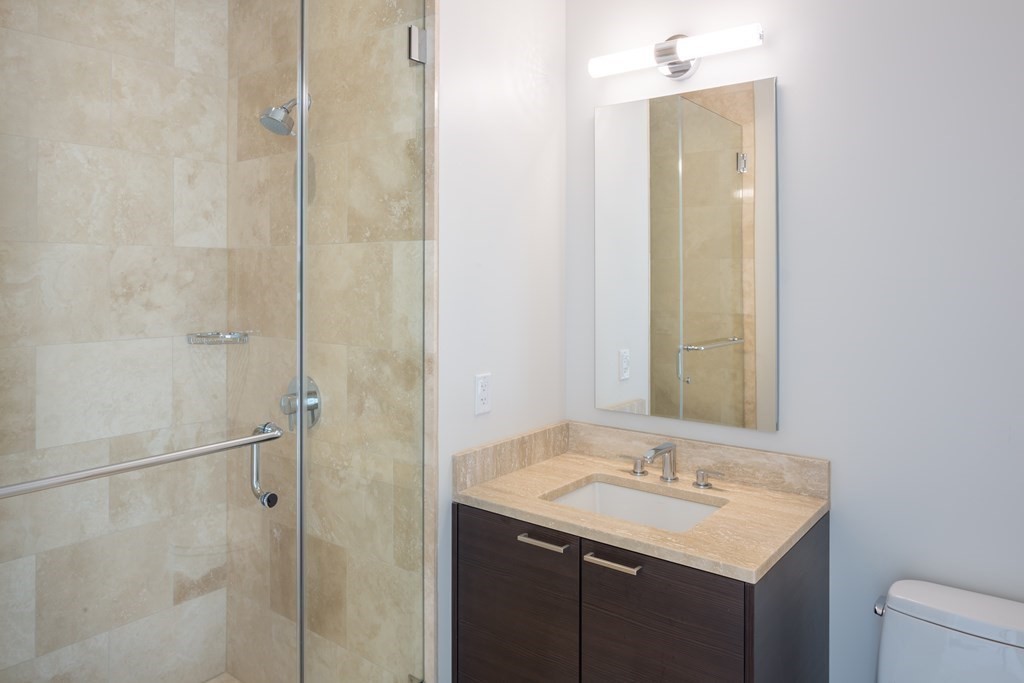 1 Franklin Street, Unit 3903 Boston, MA 02110 - Photo 8 of 26 a bathroom with a sink and a mirror