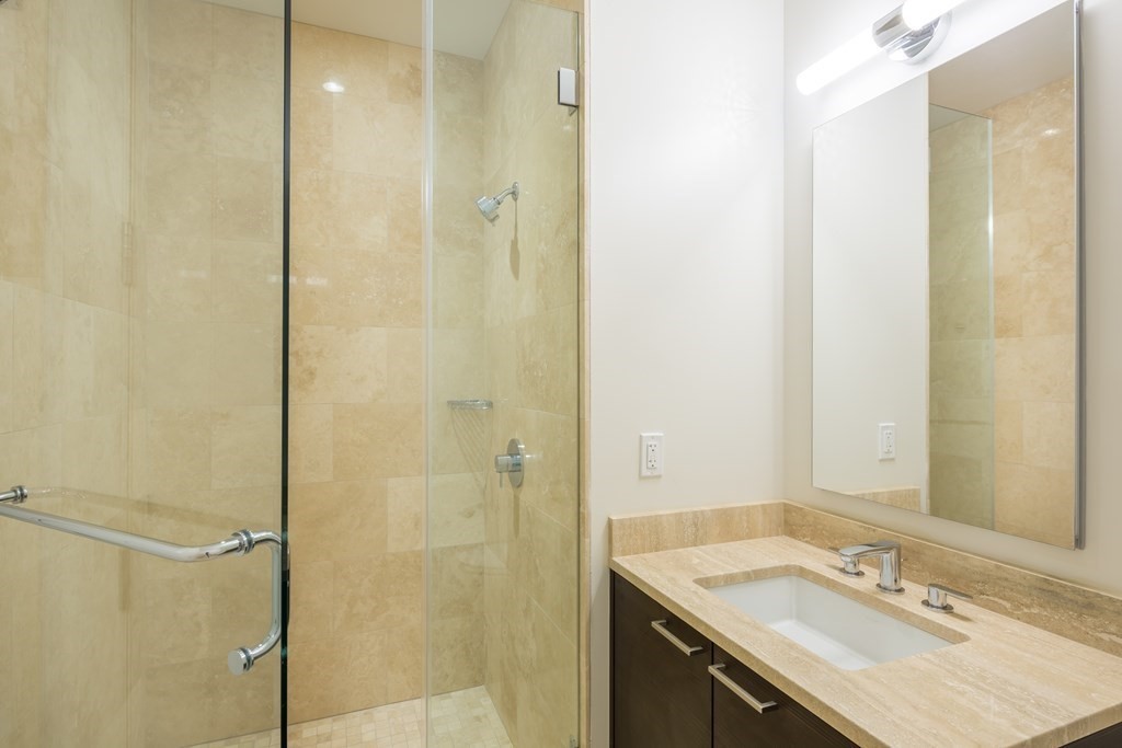 1 Franklin Street, Unit 3903 Boston, MA 02110 - Photo 10 of 26 a bathroom with a sink shower and a mirror