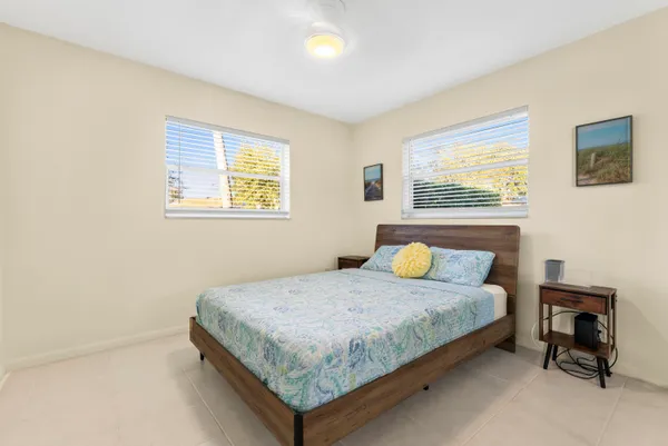 a bedroom with a bed and wall painting