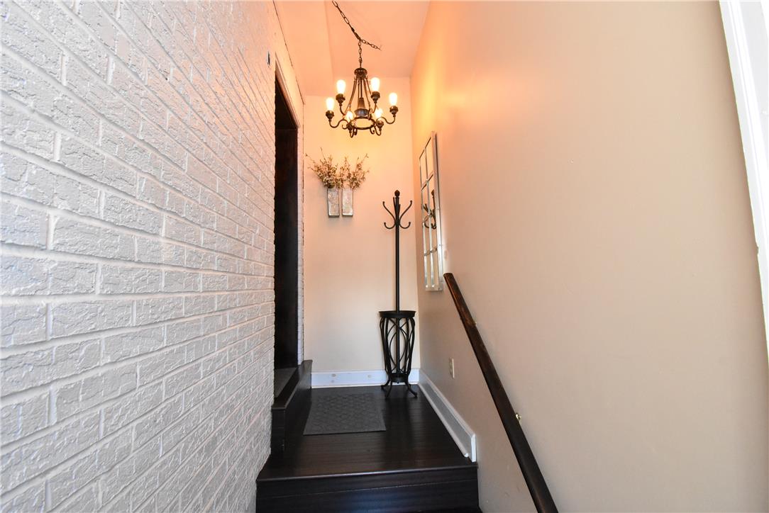 424 Grape Street Whitehall, PA 18052 - Photo 11 of 50 This entry hall features dark wood floors, a stylish chandelier, and exposed brick for a welcoming feel.