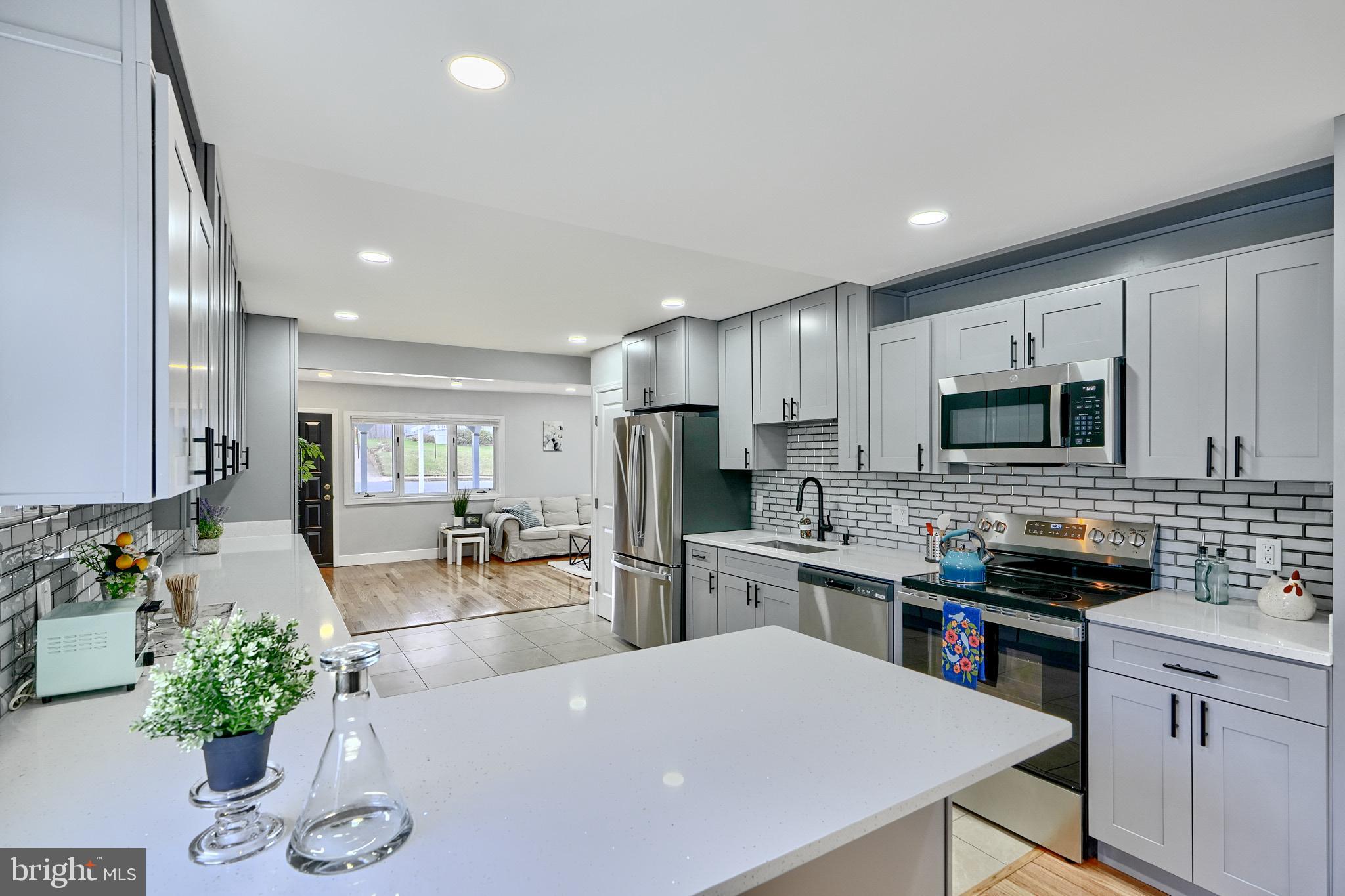 709 Fuselage Avenue Baltimore, MD 21221 - Photo 14 of 36 a kitchen with refrigerator and cabinets