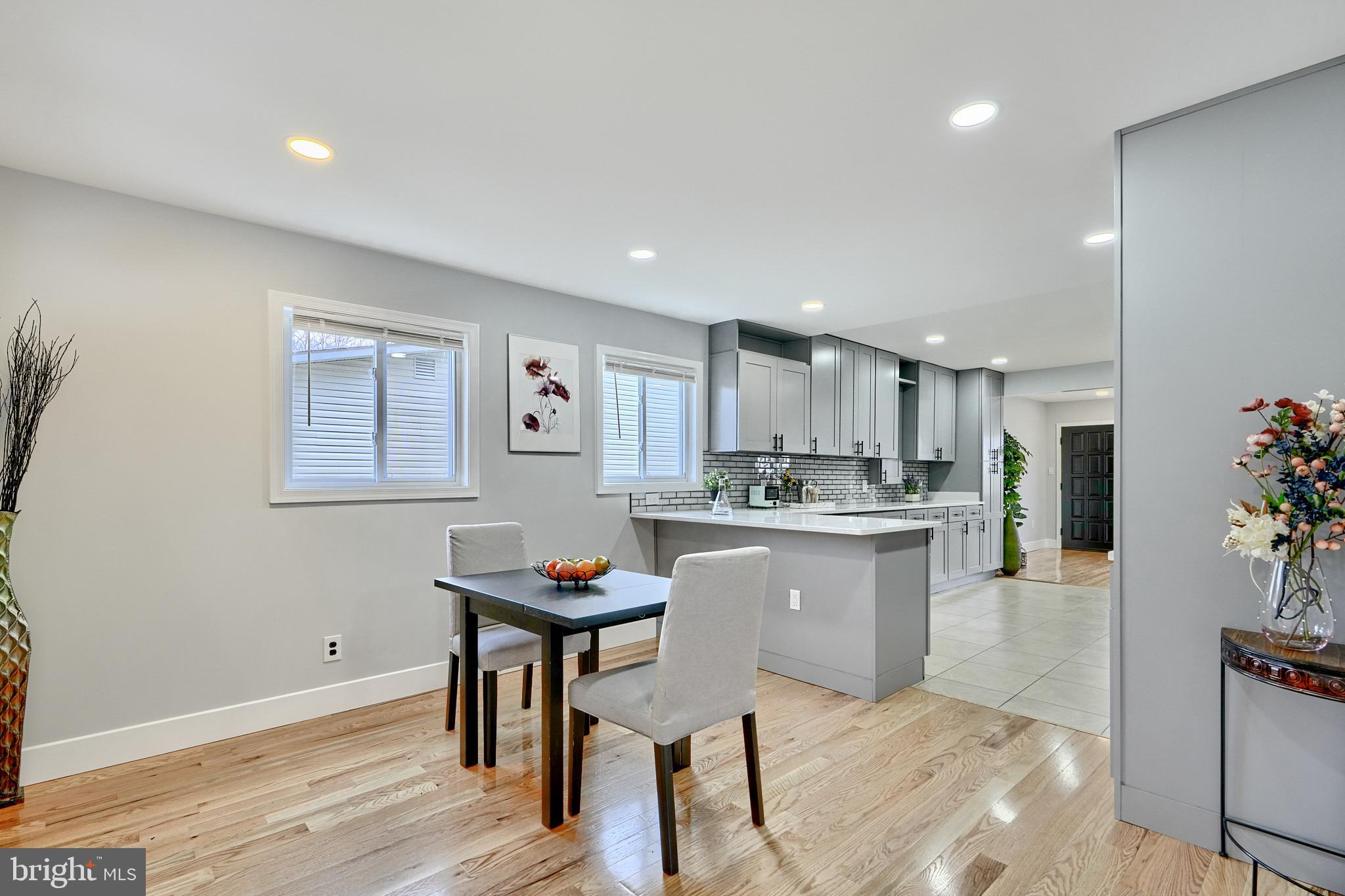 709 Fuselage Avenue Baltimore, MD 21221 - Photo 15 of 36 a kitchen with a sink cabinets and wooden floor