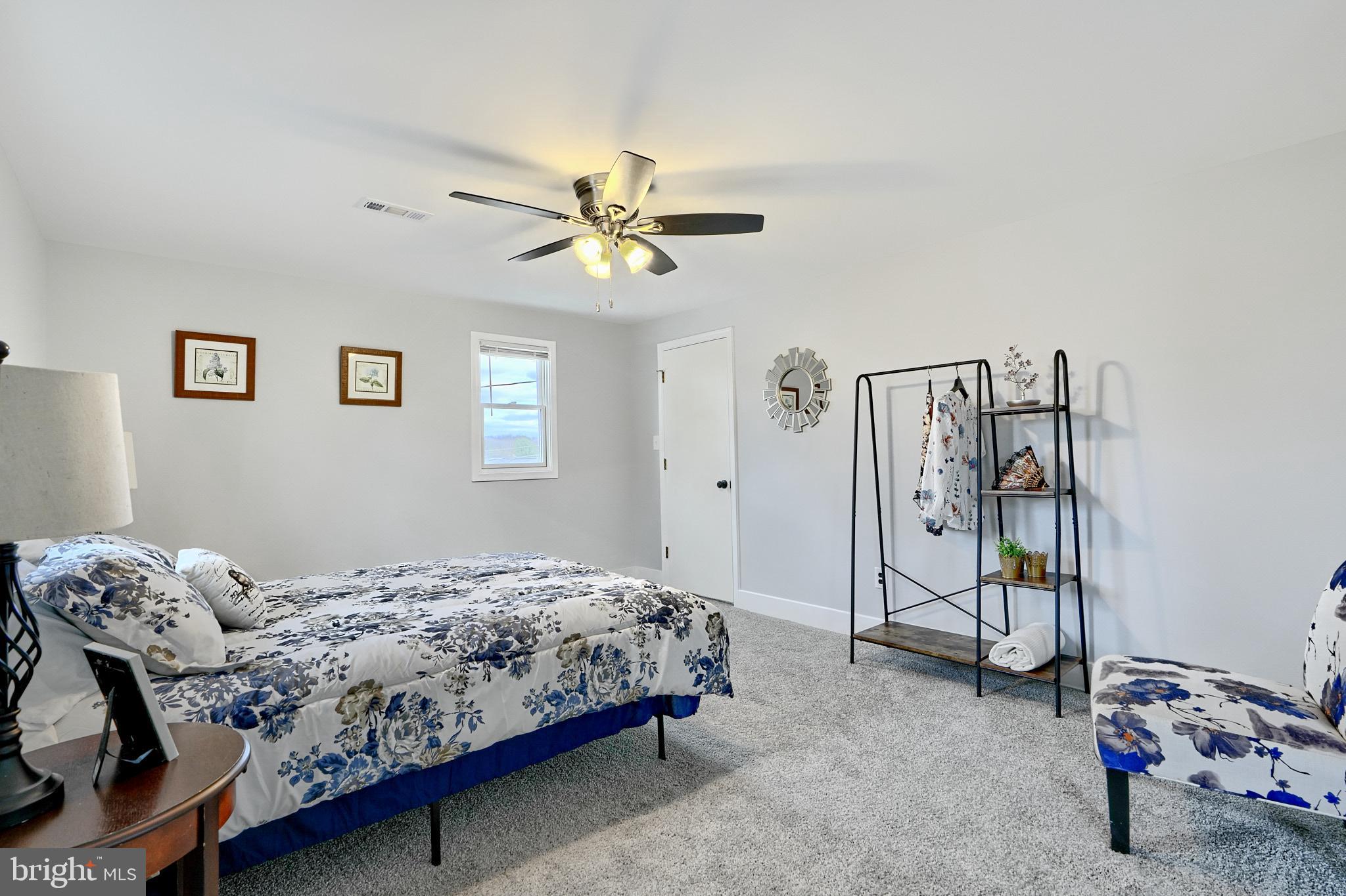 709 Fuselage Avenue Baltimore, MD 21221 - Photo 24 of 36 a bedroom with a bed and a chandelier