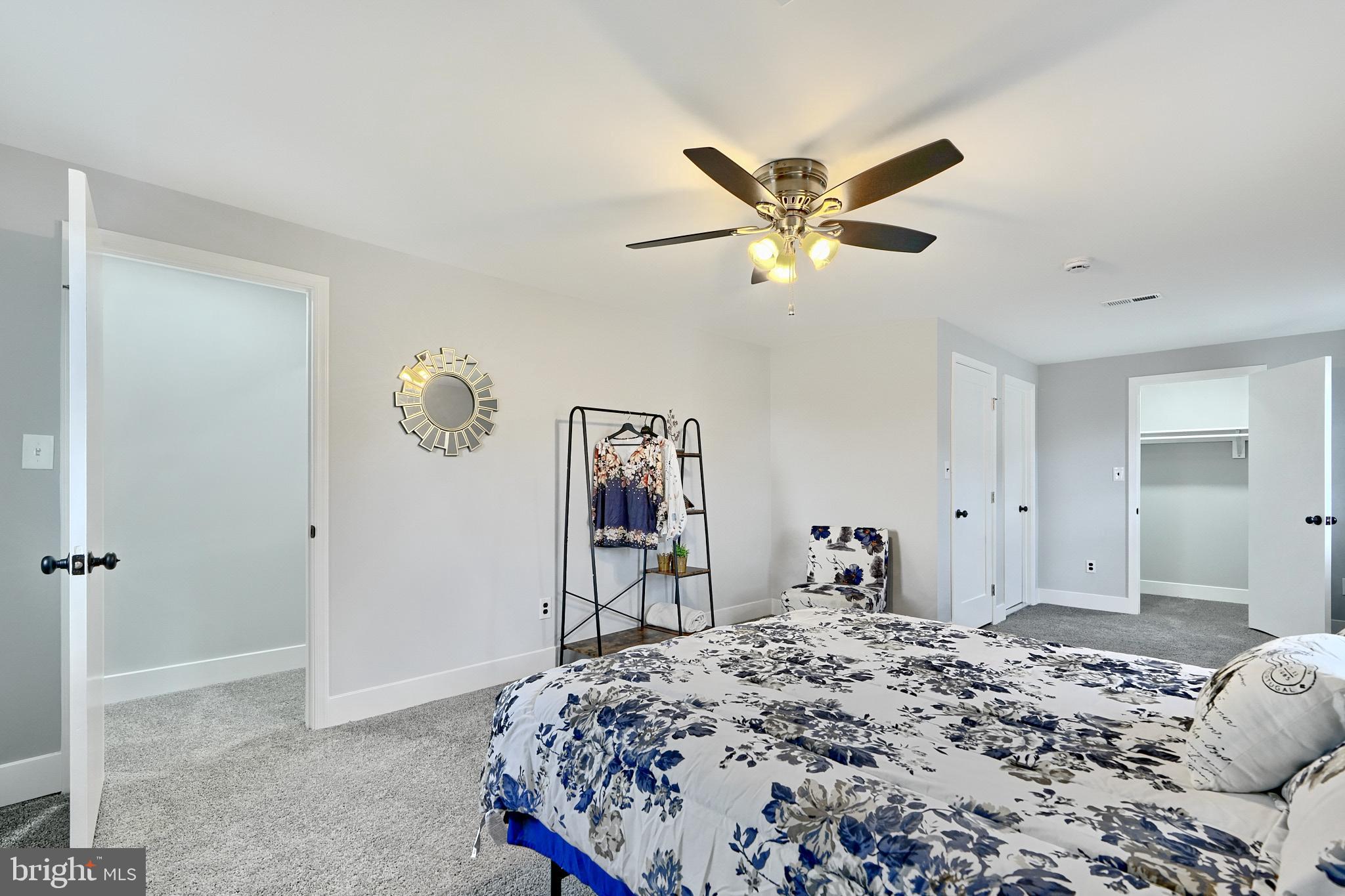 709 Fuselage Avenue Baltimore, MD 21221 - Photo 26 of 36 a bedroom with a bed and a chandelier
