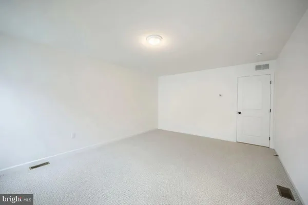 a bathroom with a double vanity sink toilet and mirror