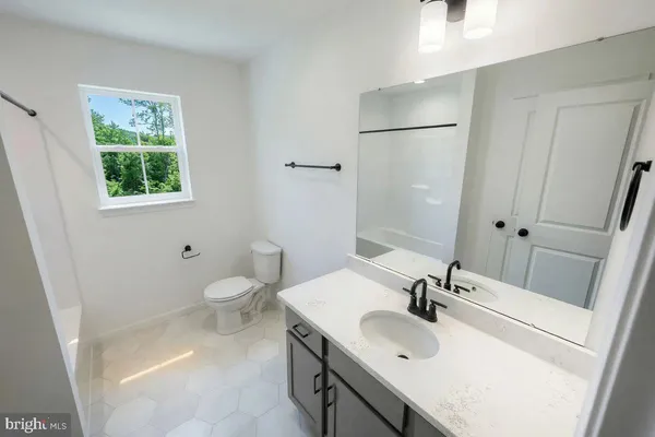 a bathroom with a sink and mirror