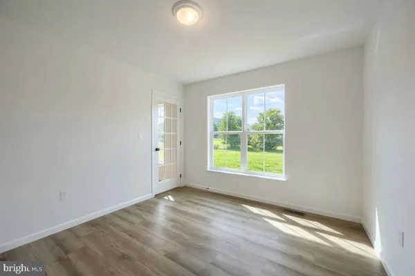 a room with furniture a rug and white walls