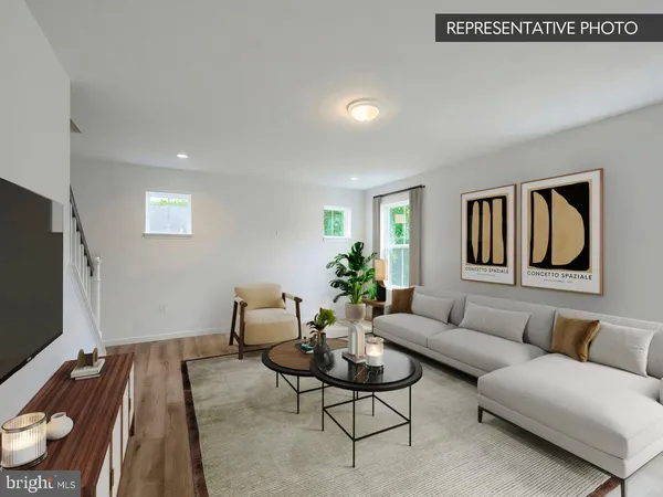 a living room with furniture a rug and a large window