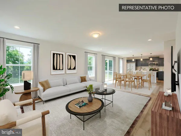 a kitchen with granite countertop a dining table chairs and white cabinets