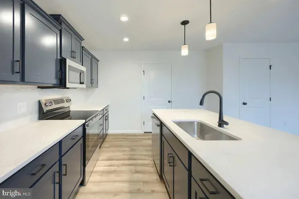 a kitchen with stainless steel appliances granite countertop a sink and dishwasher