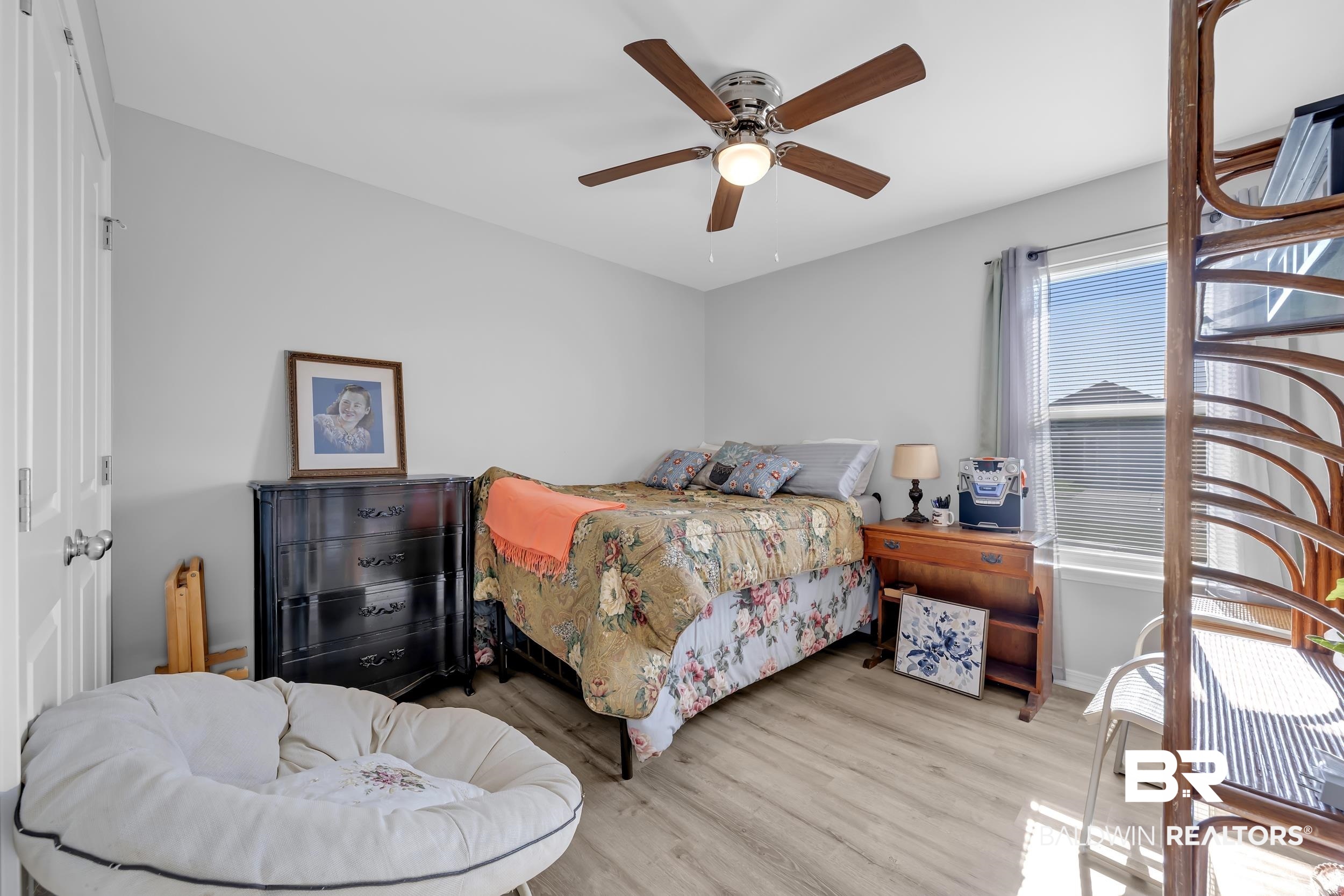 1228 Caper Avenue Foley, AL 36535 - Photo 29 of 54 Bedroom featuring wood-finish flooring, a ceiling fan with integrated lighting, and neutral wall tones
