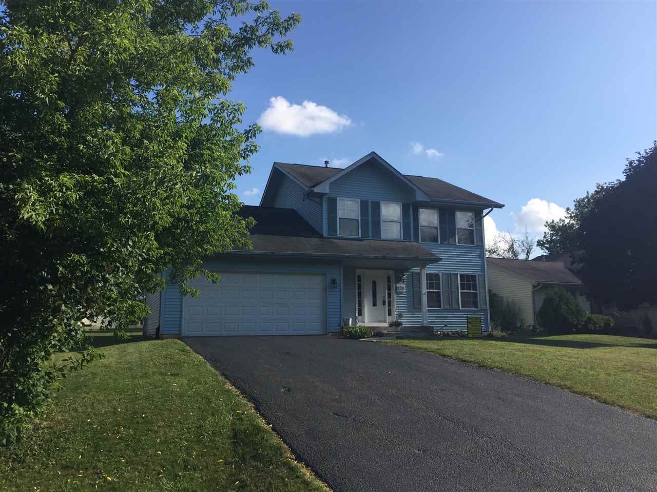 128 Pembroke Road Southwest Poplar Grove, IL 61065 - Photo 1 of 9 a front view of a house with a yard and garage