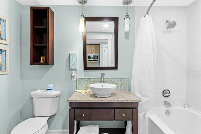 a bathroom with a toilet a sink and a mirror