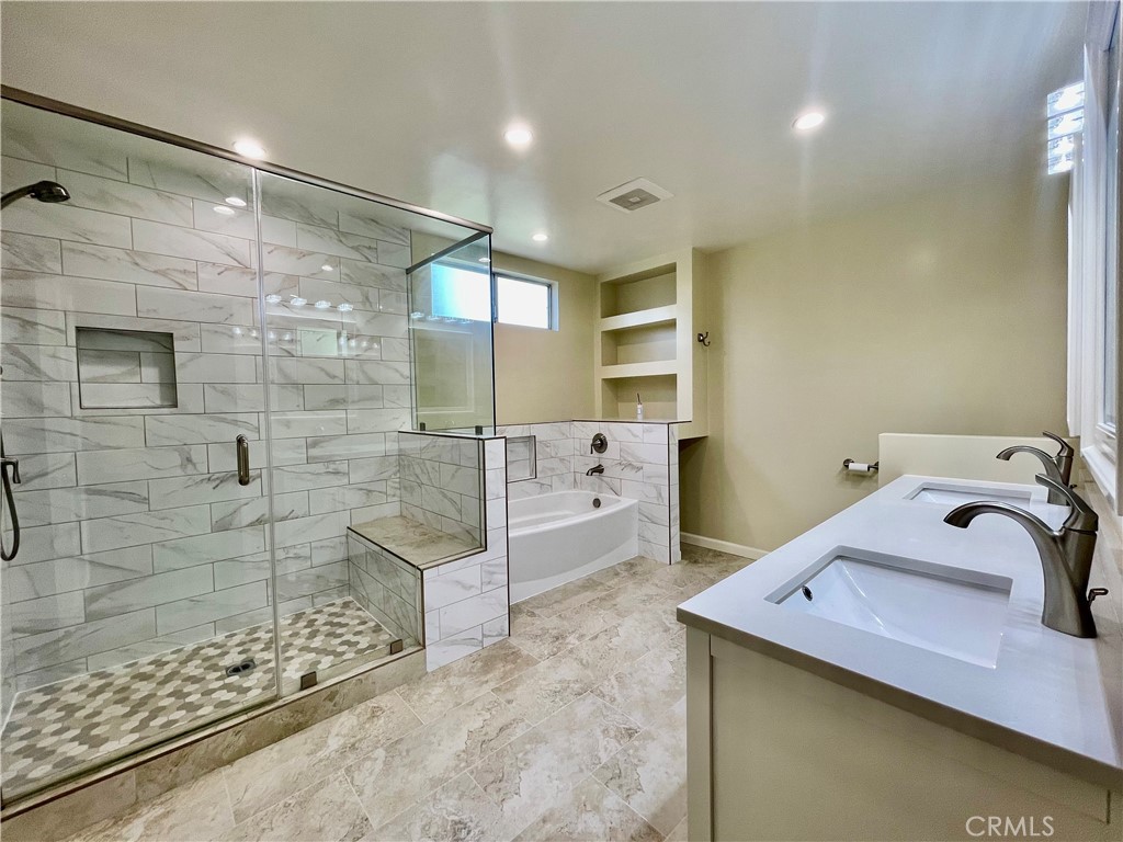 3921 Declaration Avenue Calabasas, CA 91302 - Photo 16 of 26 a bathroom with a tub sink and shower