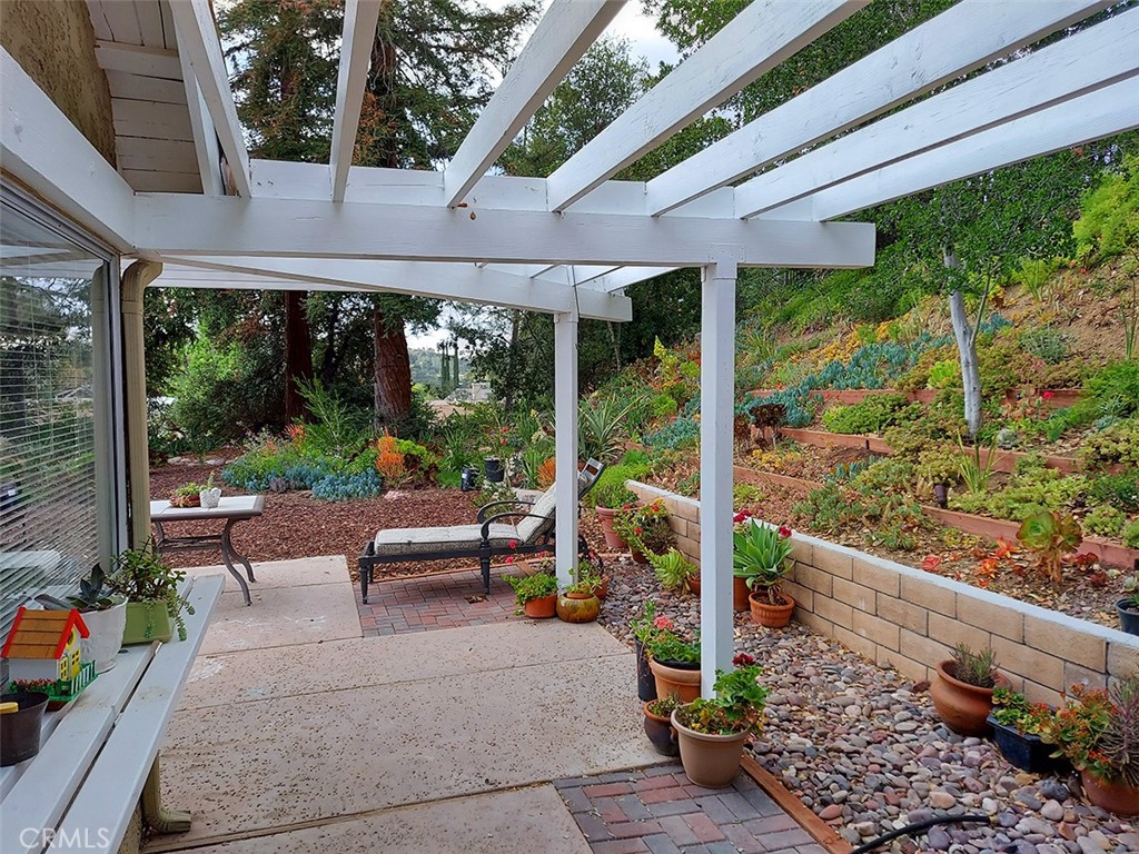 3921 Declaration Avenue Calabasas, CA 91302 - Photo 17 of 26 a view of a patio with chairs and floor to ceiling window