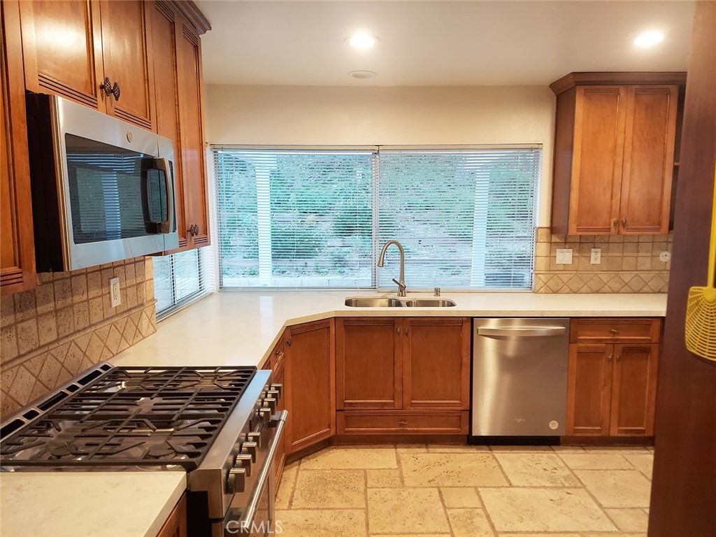 3921 Declaration Avenue Calabasas, CA 91302 - Photo 7 of 26 a kitchen with a sink and a stove next to a window
